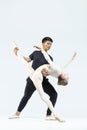 Couple of Asian Young Man and Caucasian Woman Performing As Ballet Dancers Over Grey in Studio During Suppots As Classical Dance Royalty Free Stock Photo