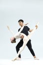 Couple of Asian Young Man and Caucasian Woman Performing As Ballet Dancers Over Grey in Studio During Suppots As Classical Dance Royalty Free Stock Photo