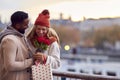 Couple In Autumn Or Fall Meeting On Date In City With Man Giving Woman Bouquet Of Flowers