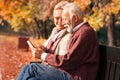 Couple in autumn park with tablet in hands Royalty Free Stock Photo
