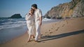 Couple awaiting child walking shore at summer family vacation. Future parents Royalty Free Stock Photo