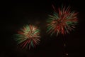 Couple of awesome red, white and green fireworks above a illuminated church Royalty Free Stock Photo
