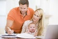 Couple and baby in dining room with laptop Royalty Free Stock Photo