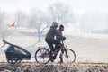 Couple with baby trailer on bicycle path Royalty Free Stock Photo