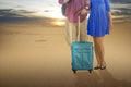 Couple with backpack and suitcase traveling to the desert