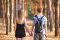 Couple with backpack in summer sunny forest.