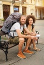 A couple of backpacker tourists sitting on a bench Royalty Free Stock Photo