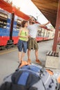 A couple of backpacker tourists waiting to board a train Royalty Free Stock Photo