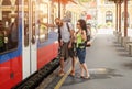 A couple of backpacker tourists waiting to board a train Royalty Free Stock Photo