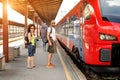 A couple of backpacker tourists waiting to board a train Royalty Free Stock Photo