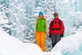 Couple backpackers and ice waterfall Royalty Free Stock Photo