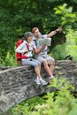 Couple of backpackers taking break and admiring nature Royalty Free Stock Photo