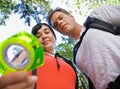Couple with backpacks looking at compass Royalty Free Stock Photo