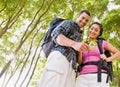 Couple in backpacks looking at compass Royalty Free Stock Photo