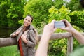 Couple with backpacks taking picture by smartphone Royalty Free Stock Photo