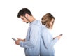 Couple backwards with their mobile phones isolated on white background Royalty Free Stock Photo