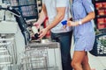 Couple with bank card buying food at grocery store or supermarket self-checkout Royalty Free Stock Photo