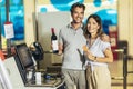 Couple with bank card buying food at grocery store or supermarket self-checkout Royalty Free Stock Photo