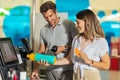 Couple with bank card buying food at grocery store or supermarket self-checkout Royalty Free Stock Photo