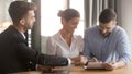 Couple and bank representative reach agreement signing loan contract Royalty Free Stock Photo