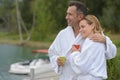 Couple in bathrobe sitting on pontoon Royalty Free Stock Photo