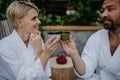 Couple in bathrobes drinking green tea, enjoying romantic wellness weekend in spa. Concept of Valentine& x27;s Day.