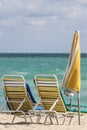 A couple of beach chairs and yellow umbrela in Miami beach