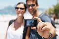 Couple, beach and digital camera for selfie on holiday with smile, sunglasses and outdoor for memory in summer. People Royalty Free Stock Photo