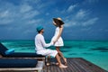 Couple on a beach jetty at Maldives