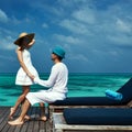 Couple on a beach jetty at Maldives