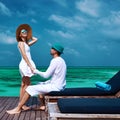 Couple on a beach jetty at Maldives