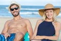Couple on beach looking at camera