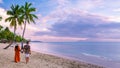 couple on beach with palm trees sunset at the tropical beach of Saint Lucia or St Lucia Caribbean Royalty Free Stock Photo