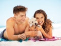 Couple, beach portrait and young puppy on vacation, bonding and love on towel to relax in summer sunshine. Man, woman Royalty Free Stock Photo