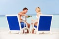 Couple On Beach Relaxing In Chairs And Drinking Champagne Royalty Free Stock Photo