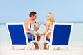Couple On Beach Relaxing In Chairs And Drinking Champagne Royalty Free Stock Photo