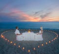 Couple at beach romantic dinner with candles heart Royalty Free Stock Photo