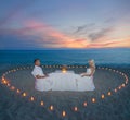 Couple at beach romantic dinner with candles heart Royalty Free Stock Photo