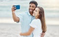 Couple, beach selfie and smile for happy travel fun, freedom day and relaxing summer vacation outdoors. Photos and young