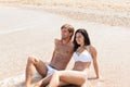 Couple on beach, sitting in water embrace Royalty Free Stock Photo