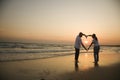 Couple on beach at sunset. Royalty Free Stock Photo