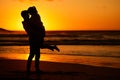 Couple, beach and sunset with a man and woman hugging on the coast with a golden view in the background. Love