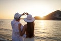 Beautiful young people in love walking. Couple on beach at sunset summer vacation Royalty Free Stock Photo