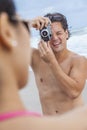 Couple at Beach Taking Photographs Royalty Free Stock Photo