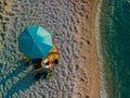 couple at the beach under sun umbrella sea vacation Royalty Free Stock Photo
