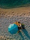 couple at the beach under sun umbrella sea vacation Royalty Free Stock Photo