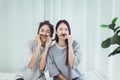 Couple beautiful asian women are having fun and making fake mustaches from hair,Happy and smiling