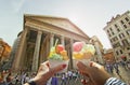 Couple with beautiful bright sweet Italian ice-cream with different flavors in the hands