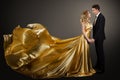 Couple, Beautiful Woman in Golden Silk Dress and Elegant Man, Fluttering Gown Royalty Free Stock Photo