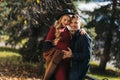 A couple of beautiful young future parents spend time in the autumn park. Young pregnant woman and a handsome man Royalty Free Stock Photo